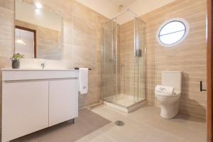 a bathroom with a toilet and a sink and a shower at Quinta Vale Leitão in Coimbra