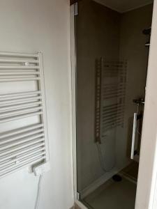 a shower stall in a bathroom with a window at Maison Solesmes nord in Solesmes
