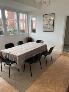 a dining room with a table and chairs at Maison Solesmes nord in Solesmes +7 photos