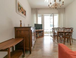 a living room with a table and a dining room at Mountain View Apartment Lecco Centro in Lecco