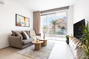a living room with a couch and a table at Chrystal Residences in Nicosia