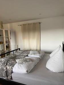 a bed with two pillows on it in a bedroom at Ferienwohnung Seeblick in Grimma