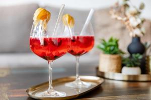 two glasses of red wine sitting on a table at Burgberg City Apartment in Daun
