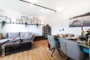 a living room with a couch and a table at Burgberg City Apartment in Daun