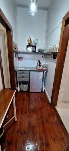 a kitchen with a counter and a wooden floor at Mitat Guesthouse in Beaufort West +49 photos