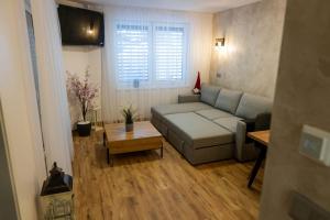a living room with a couch and a table at Apartmán u Pivovaru in Rožnov pod Radhoštěm