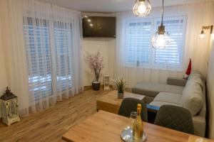 a living room with a couch and a table at Apartmán u Pivovaru in Rožnov pod Radhoštěm