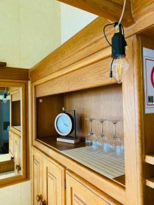 a counter with wine glasses and a clock on it at Frontline Holiday apartment in Durban