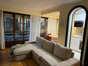 a living room with a couch and a table at Duplex Arriondas in Arriondas