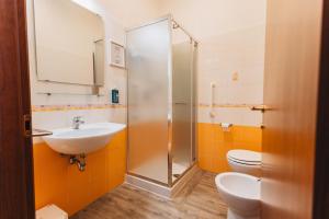 a bathroom with a shower and a sink and a toilet at Locanda Del Picchio in Loreto +44 photos
