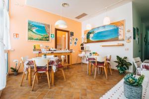 a restaurant with tables and chairs in a room at Locanda Del Picchio in Loreto