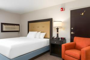 a hotel room with a bed and a chair at Branson Hillside Hotel in Branson +33 photos
