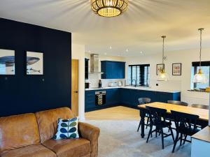 a living room and kitchen with a couch and a table at Pingle Nook Barn on the Farm - Denby Dale in Huddersfield