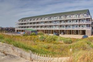 a large building sitting on top of a beach at Oceanfront, dog-friendly condo with ocean view, pool & central AC in Hatteras