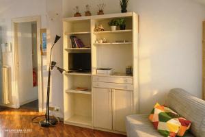a living room with a white book shelf at The Central Milano in Milan