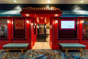 a restaurant with red walls and benches and a screen at Virgin River Casino and Lodge in Mesquite