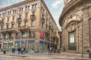 people walking on a street in front of a building at The Central Milano in Milan