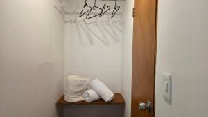 a bathroom with towels on a shelf next to a door at ABC-53 Housing in Medellín +60 photos