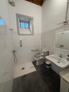 a white bathroom with a sink and a toilet at Casa Antigua Arona in Arona +125 photos