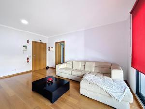 a living room with a couch and a coffee table at Sea Garden in Caniço