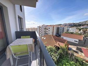 a balcony with a table and chairs on a balcony at Sea Garden in Caniço