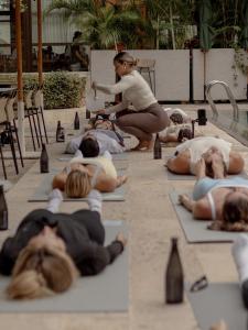 a group of people laying on the ground doing yoga at Osh Hotel Cartagena in Cartagena de Indias