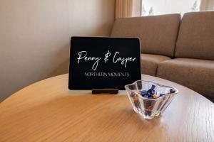 a laptop on a table with a bowl on it at Levi City Suite - Central & Stylish with Free Ski Passes in Levi