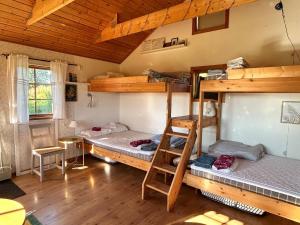 a room with two bunk beds in a cabin at Ulvsby Ranch Western Camp in Karlstad