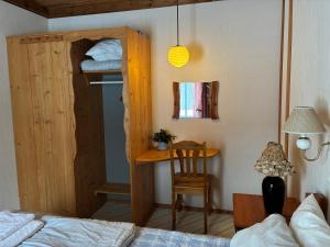 a bedroom with a bunk bed and a desk at Runneröd in Saltvik
