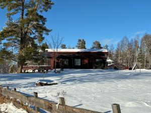 a building with snow on the ground in front of it at Runneröd in Saltvik