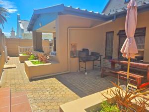 a small house with a patio with a piano at Vitamiene-See Hartenbos in Hartenbos