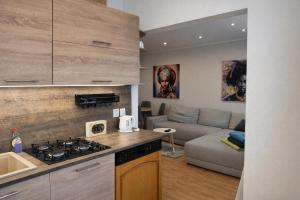 a kitchen and living room with a stove and a couch at Apartmán MARKI in Malacky