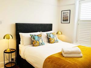 a bedroom with a large white bed with pillows at Thorpe House - Fylingthorpe in Fylingthorpe