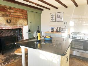 a kitchen with a counter with two glasses of wine at Thorpe House - Fylingthorpe in Fylingthorpe +14 photos