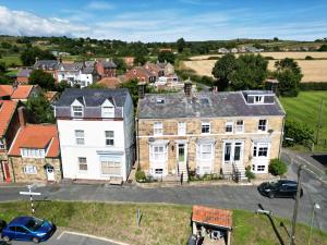 an aerial view of a large house in a town at Thorpe House - Fylingthorpe in Fylingthorpe