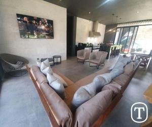 a living room with a large couch in the middle at Quinta La Terquedad in Montemorelos