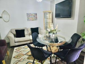 a living room with a glass table and chairs at Room 3 Shared House in Bootle in Litherland +16 photos