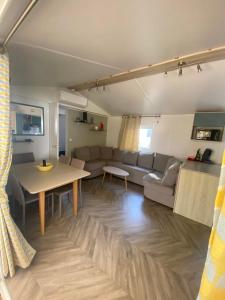 a living room with a couch and a table at mon paradis in Lattes