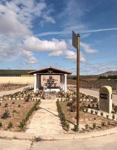 a sign in front of a building in a field at Casa Rural Solterra in Roa