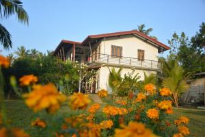 a house with flowers in front of it at Suwetha villa Ayurveda Resort in Bentota