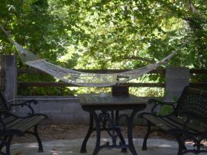 a hammock sitting on a table with two benches at Dodis Village in Platanias