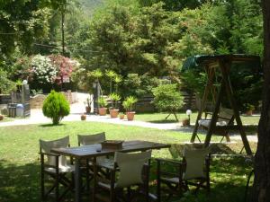 a wooden table and chairs in a yard at Dodis Village in Platanias