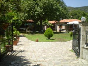 a gate to a yard with a house and a garden at Dodis Village in Platanias