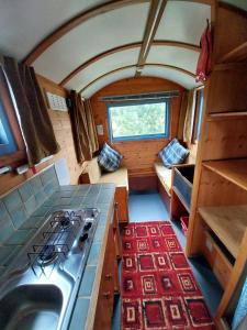 a kitchen with a stove and a stove top at EcoPod Holidays in Alton