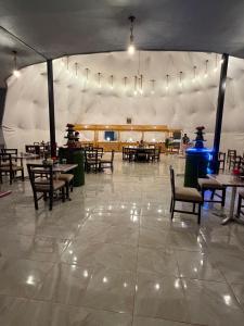 a dining area with tables and chairs in a tent at Rina Luxury Camp in Wadi Rum +50 photos