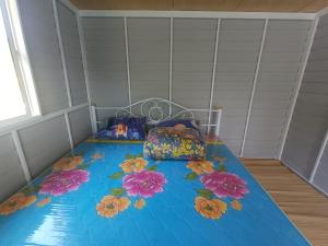 a bed with flowers on it in a room at S&A Camping in Ban Kum +16 photos