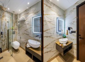 a bathroom with two sinks and a shower at Hotel Bella Express in New Delhi +62 photos