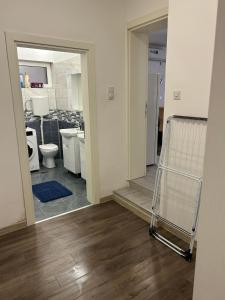 a room with a bathroom with a toilet and a cart at Apartmani Centar in Sivac +44 photos
