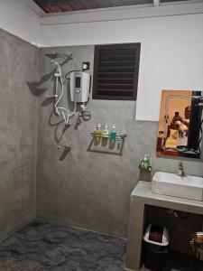 a bathroom with a sink and a mirror at Lake & Ocean Villa ahangama in Elagawagoda +27 photos