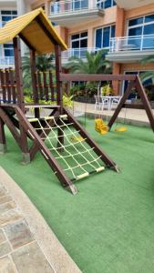 a playground with a play set on the grass at PREMIUM Puerto Varadero Apartamento con Vista al Mar y Planta Total in Tucacas